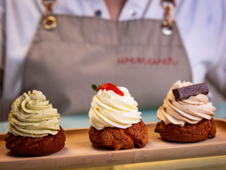 Gourmet Cream Puffs | Founders’ Food Hall & Market Desserts Charlottetown Trio of gourmet cream puffs topped with matcha, strawberry, and chocolate displayed at Founders’ Food Hall & Market in Charlottetown, PEI.