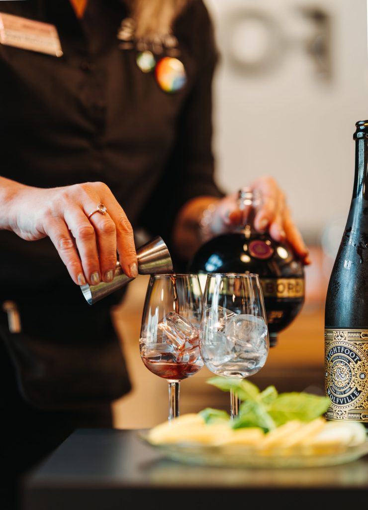 Craft Cocktails at Notables – Founders’ Food Hall Charlottetown Staff member preparing tasting cocktails with Chambord and sparkling wine at Notables in Founders’ Food Hall, Charlottetown