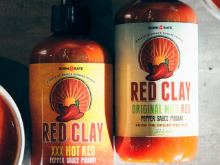 Red Clay Hot Sauce by Maritime Madness – Made in PEI Two bottles of Red Clay hot sauce from Maritime Madness in PEI – XXX Hot Red and Original Mild Red varieties
