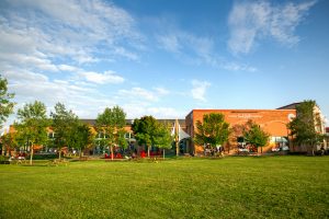Founders’ Food Hall & Market outdoor area with seating, trees, and blue sky in Charlottetown PEI