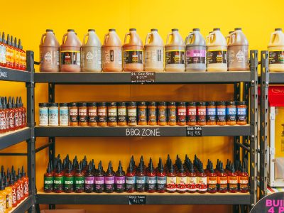 Shelves Stocked with Maritime Madness BBQ sauces, rubs, and large-size bottles.