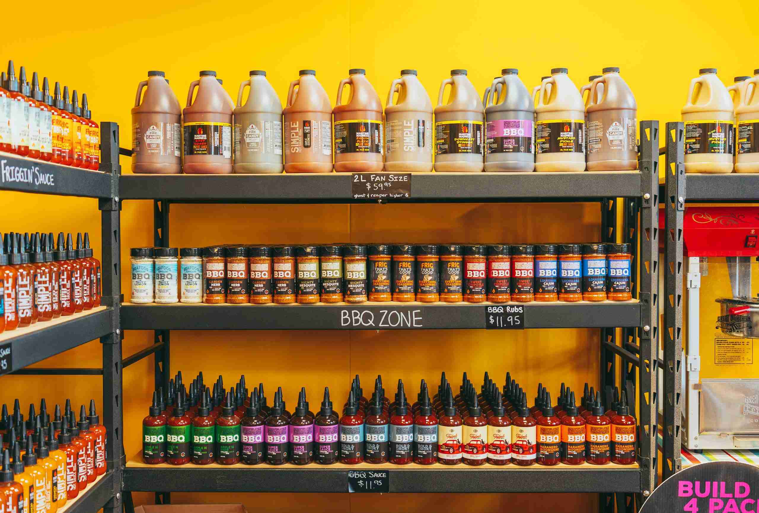Shelves Stocked with Maritime Madness BBQ sauces, rubs, and large-size bottles.