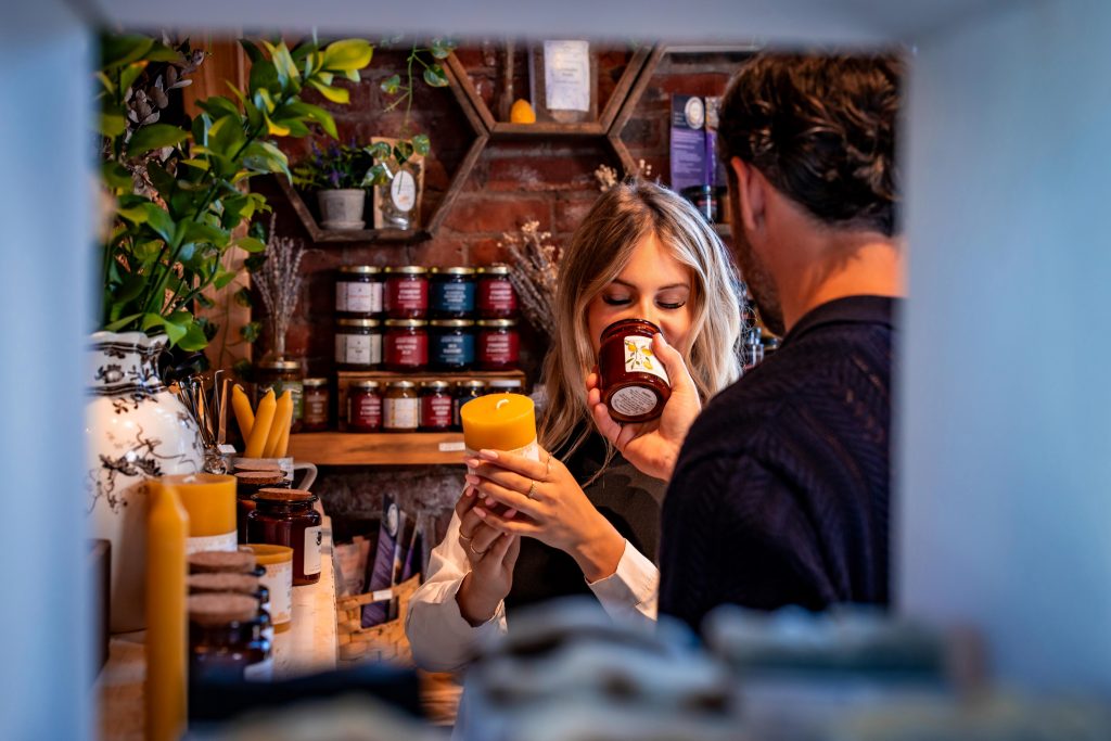 Couple smelling handcrafted candles at a local PEI shop inside Founders’ Food Hall & Market