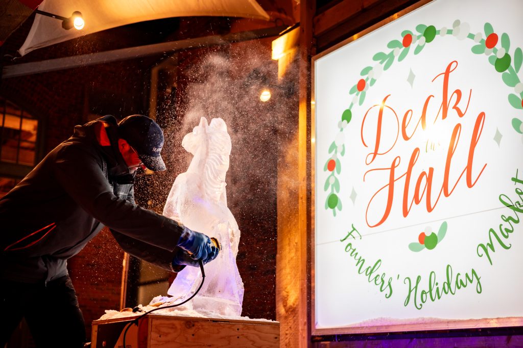 Ice sculptor carving a horse sculpture during Deck the Hall holiday event at Founders Food Hall in Charlottetown PEI