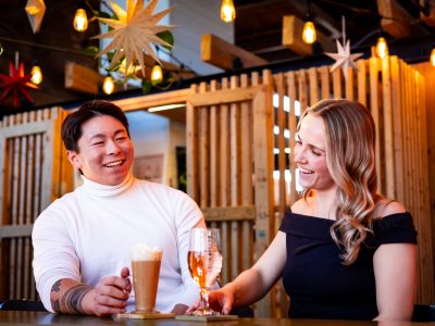 Couple enjoying drinks together at Founders’ Food Hall & Market in Charlottetown during a cozy Valentines Day outing