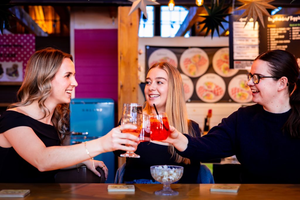 Friends enjoying drinks at Founders Food Hall & Market in Charlottetown PEI
