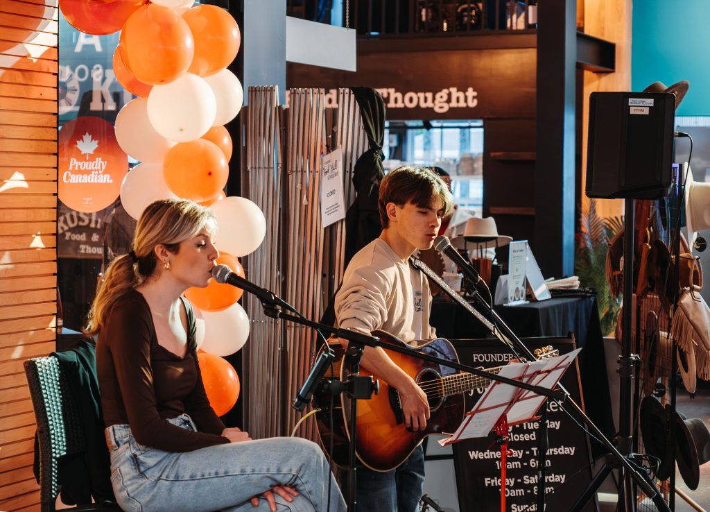 Local musicians performing live music inside Founders Food Hall during March Break events in Charlottetown PEI