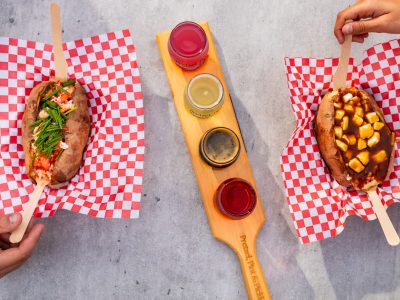 Loaded baked potatoes with toppings and sauce flight from a Founders Food Hall vendor in Charlottetown