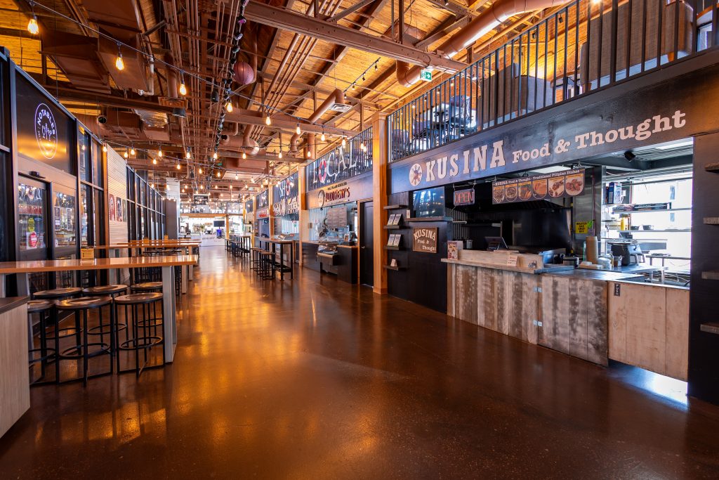 Interior of Founders Food Hall in Charlottetown with local food vendors and seating area for grab and go dinner options