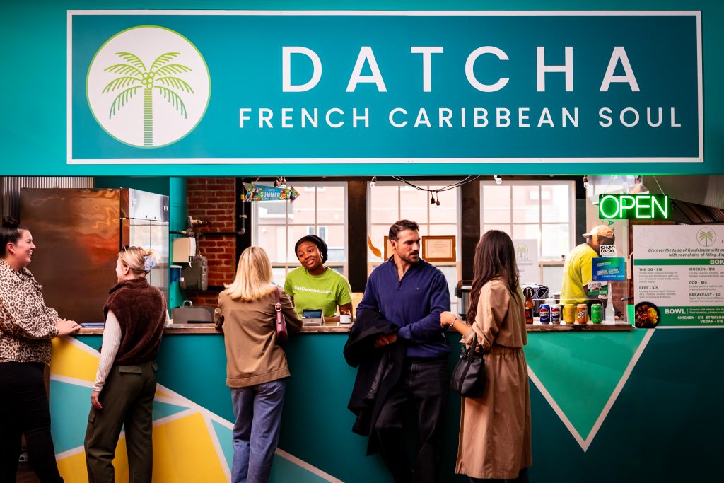 Customers ordering at Datcha French Caribbean Soul vendor inside Founders Food Hall in Charlottetown
